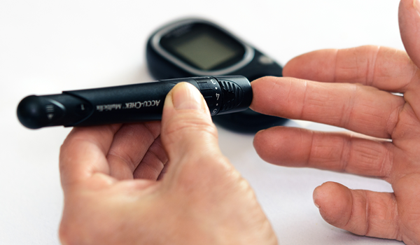 a person measuring their blood sugar levels